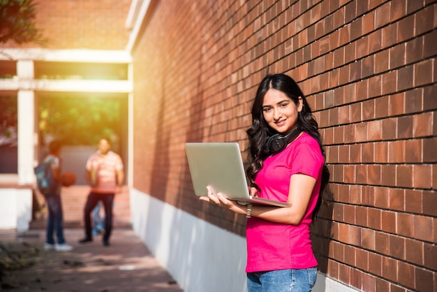 Campus Girl Stands with Laptop